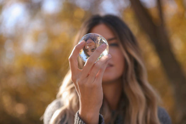 istock Woman looking into glass ball 861795050