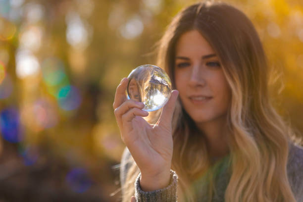 istock Woman looking into glass ball 861795086