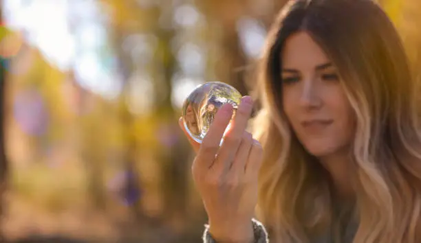 Woman looking into glass ball