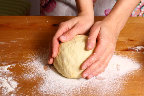 istock Home food. Making dough by female hands on kitchen table. 861797942