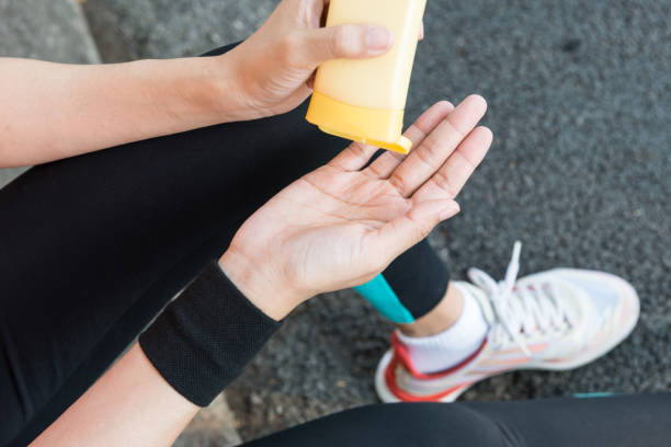 istock Young Asian female runner sitting down putting lotion on hand 861798360