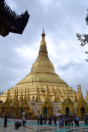 The national religious symbol of Burmese. It's the shwedagon Pagoda with its golden stupa, and many people visiting this place. Pic was taken in Yangon, Burma - August 2015.