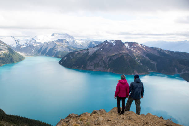 istock Young couple embracing nature and the view 861798640