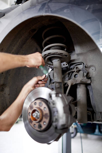 istock An unidentified mechanic repairing brake pads with tools 861804528