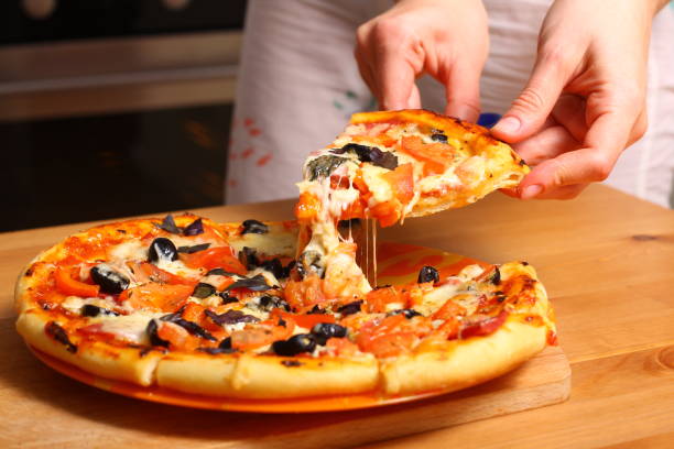 istock Woman hands sliced pizza. 861804580
