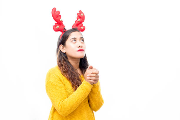 istock Serious girl praying about miracle at Christmas 861804888