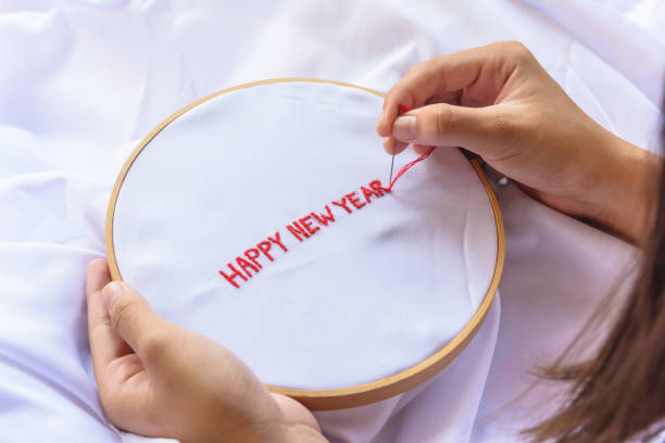 istock Handmade a text happy new year with sewing needle on white garment background. Concept and idea happy new year background 861805154