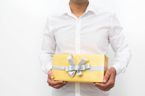 istock Cropped View of Man Holding Yellow Gift Box 861807774