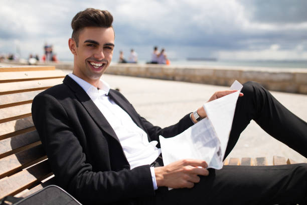 istock Cheerful student looking for job in newspaper 861814420