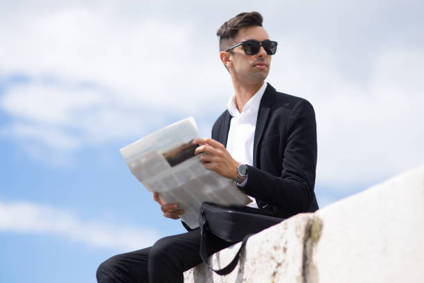 istock Purposeful businessman with newspaper looking away 861814458