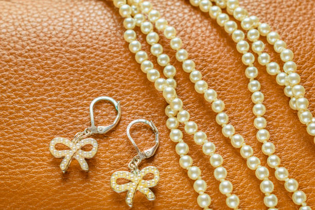 istock Pearls Necklace and Earrings on Leather Background 861814550