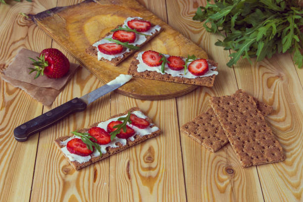 istock Wholegrain rye crispbread crackers with cream cheese, strawberry and arugula 861817304