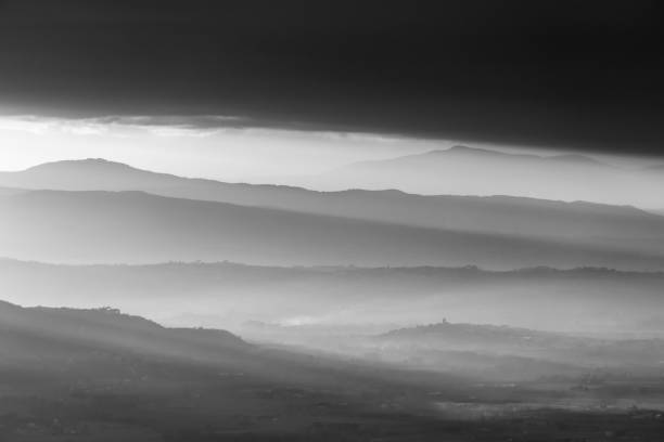 istock A valley filled by mist, with emerging hills and soft tones, beneath dark clouds 861817642