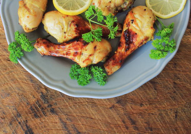 istock Grilled chicken legs with mustard on cutting board.Rustic dinner background . Top view 861820758