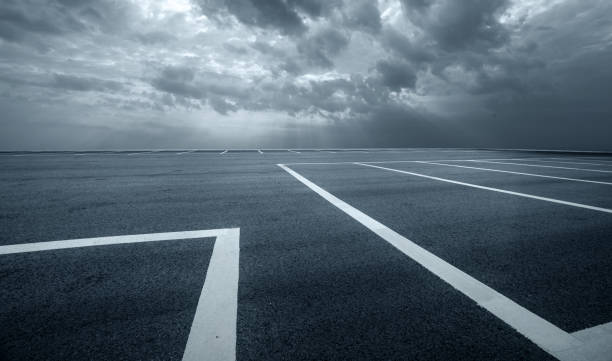 istock parking lot with black asphalt under dramatic sky 861838040