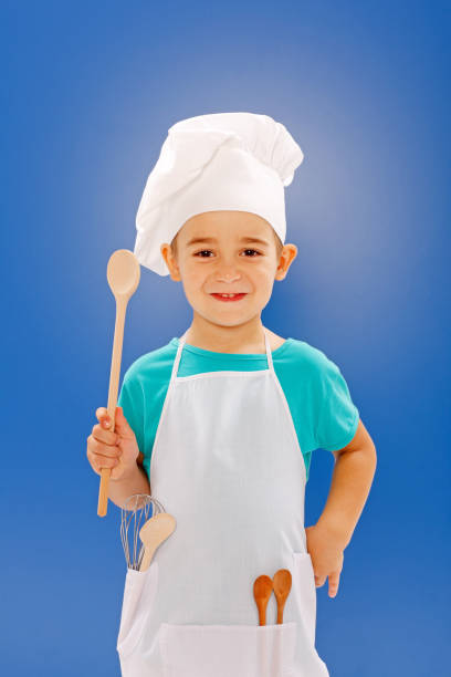 istock Little chef showing wooden spoon 861841646