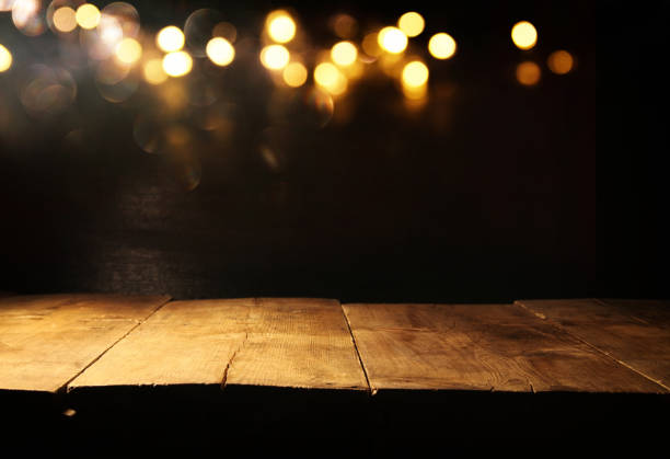 istock Empty table in front of black and gold glitter lights background 861844084