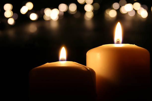 istock Burning candles over black background with bokeh glitter lights 861844092