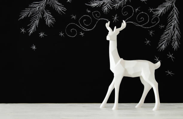 istock White reindeer on wooden table over chalkboard background whith hand drawn chalk illustrations 861844100