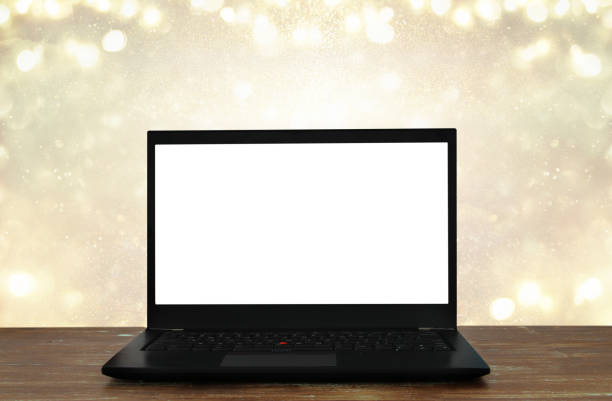 istock open laptop with white screen on wooden table in front of abstract glitter background 861844116