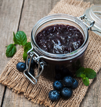 Jar with blueberry jam on a table