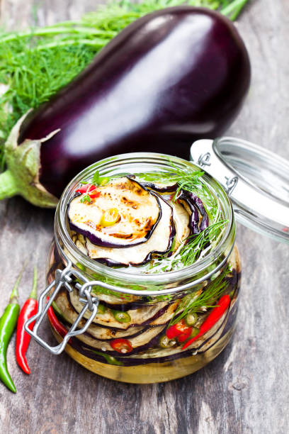 istock Grilled  sliced eggplant with chili in glass jar on rustic table. 861846910