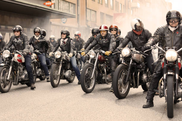 Group of tough bikers in leather clothes on retro motorcycles at the Mods vs Rockers event STOCKHOLM, SWEDEN - SEPT 02, 2017: Group of tough bikers in leather clothes on retro motorcycles at the Mods vs Rockers event at the Saint Eriks bridge, Stockholm, Sweden, September 02, 2017 motorcycle biker stock pictures, royalty-free photos & images