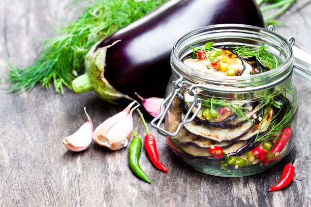 istock Grilled  sliced eggplant with chili in glass jar on rustic table. 861850022