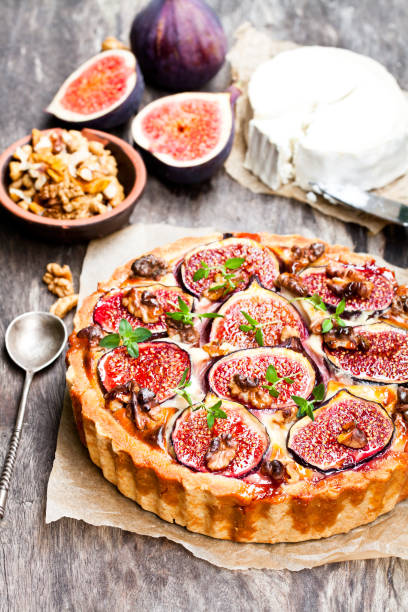 istock Delicious  tart with fresh figs and goat cheese on rustic wooden table 861850344