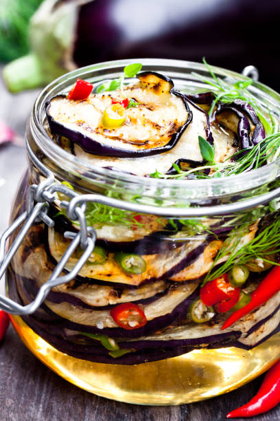 istock Grilled  sliced eggplant with chili in glass jar on rustic table. 861850760