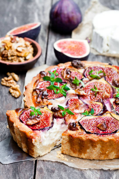 istock Delicious  tart with fresh figs and goat cheese on rustic wooden table 861850994