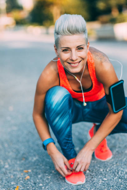 istock Sportwoman tying her shoe laces 861853220