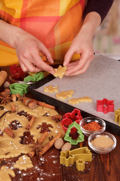 istock Woman lays biscuits for baking on baking tray, on table 861859036