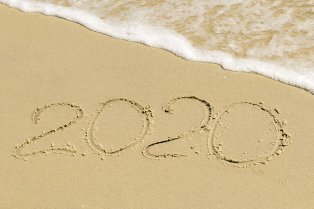 istock 2020 inscription on sand with sea foam 861859294