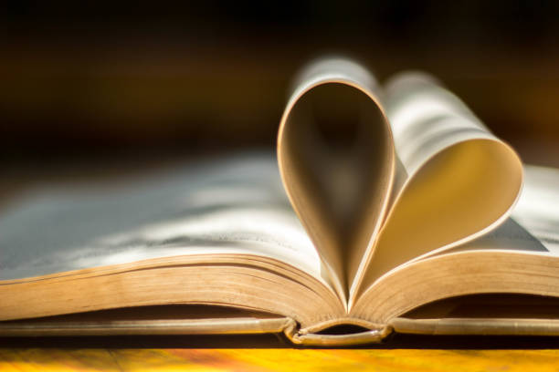 istock Gold wedding ring heart book blackground blur 861861932
