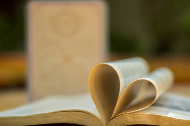 istock Gold wedding ring heart book blackground blur 861861934