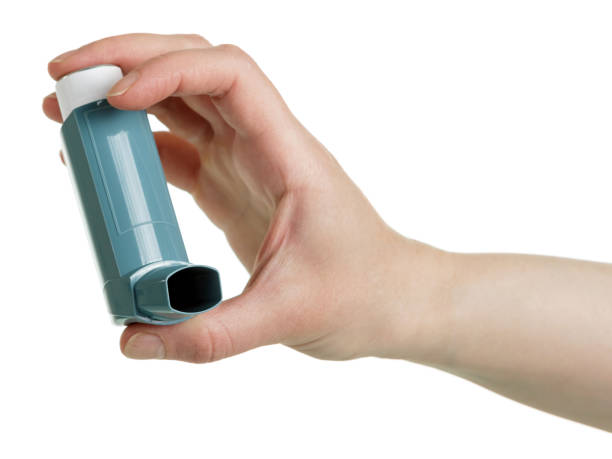 istock Asthma inhaler in female hand isolated on white background. 861862652