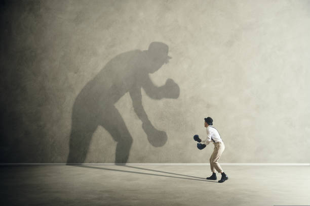 istock man fighting with his shadow, facing fears 861865034
