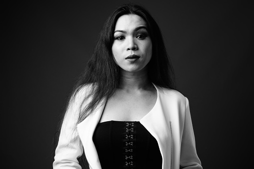 Studio shot of young beautiful Asian transgender businesswoman in black and white horizontal shot