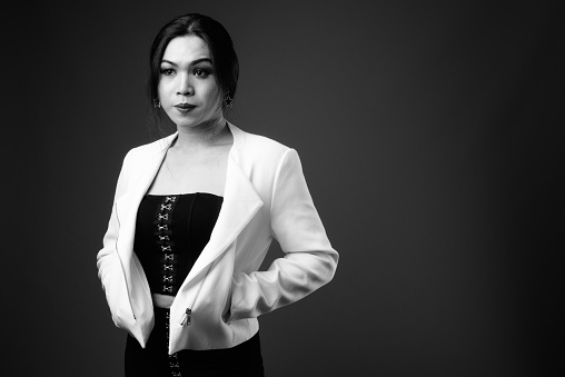 Studio shot of young beautiful Asian transgender businesswoman in black and white horizontal shot