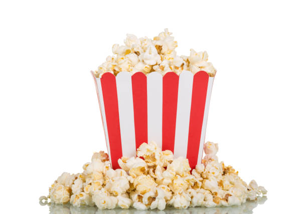 istock Square box filled with popcorn, part scattered, isolated on white 861868276