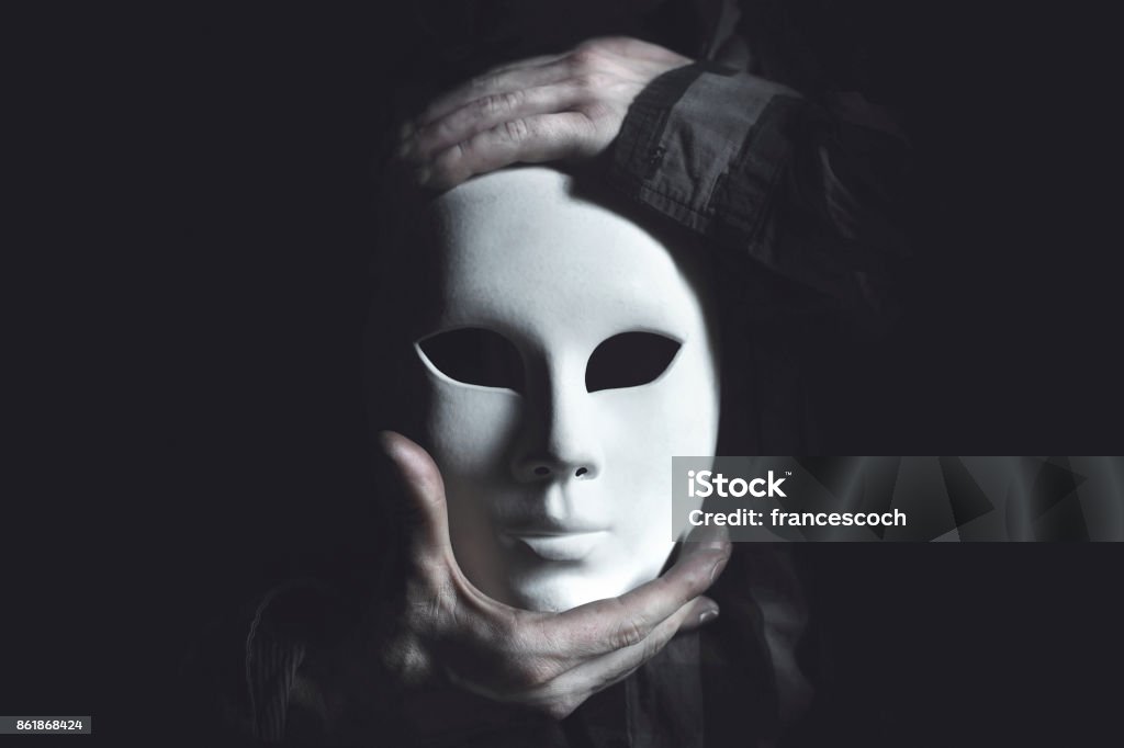hands holding white mask theater white mask Mask - Disguise Stock Photo