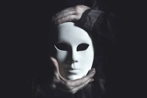 Photo of hands holding white mask