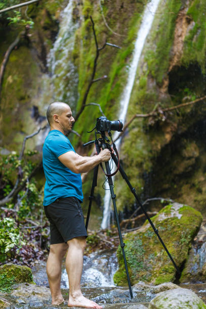 istock Professional landscape photographer shooting a waterfall 861869822