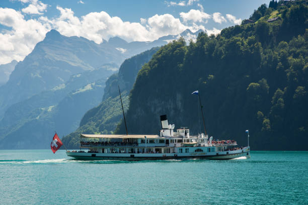 Boat on lake Lucerne in Switzerland BRUNNEN, SWITZERLAND - AUGUST 2017 - Ship full of tourists on Lake Lucerne near Brunnen in Switzerland schwyz stock pictures, royalty-free photos & images