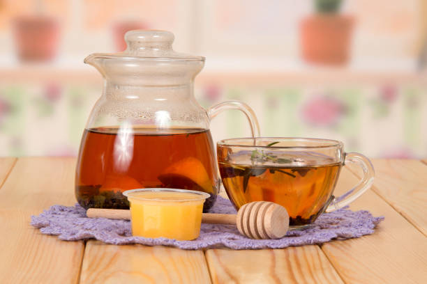istock Jug and cup with hot tea and honey, on table 861873768