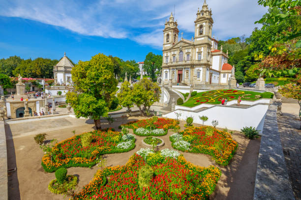 Aerial view of neoclassical Bom Jesus do Monte Sanctuary and magnificent flowered gardens in a sunny day. Tenoes near Braga. The Basilica is a popular landmark and pilgrimage site in northern Portugal
