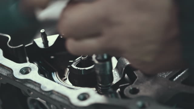 Professional mechanic repairing a continuously variable transmission