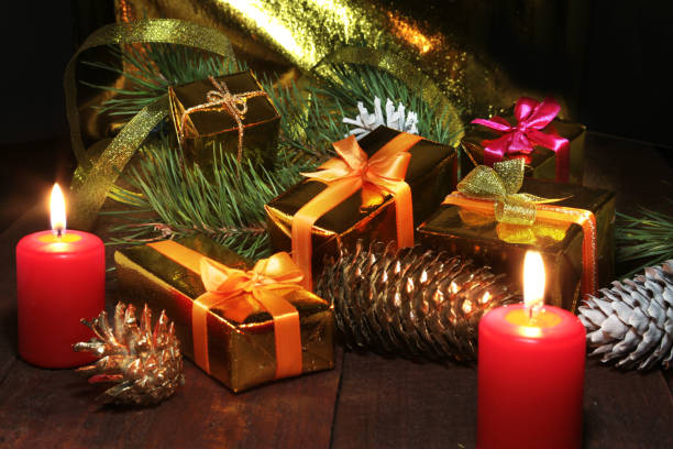 istock Christmas gift colored boxes, cones, Christmas tree and candles on a wooden table. Composition of celebrities. Selective focus. 861876942