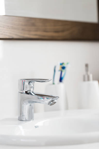 istock Modern silver tap in bathroom close up 861881080
